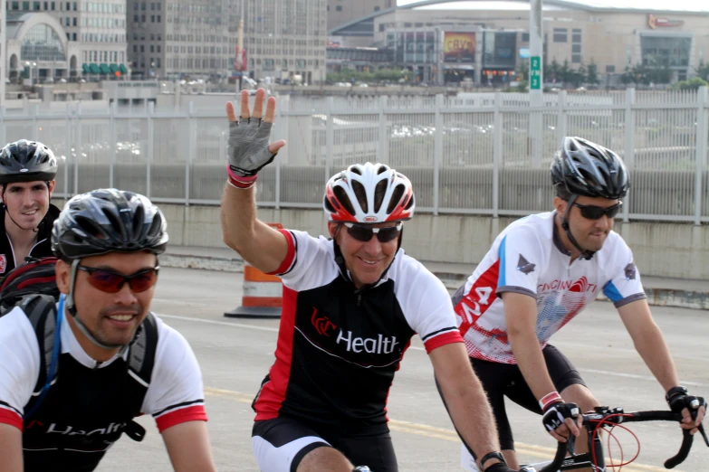 several people on bikes wearing helmets with the same bike