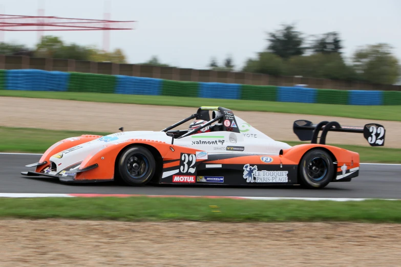 a car is going fast down a track in a race