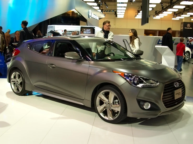 a gray car on display at an automobile show