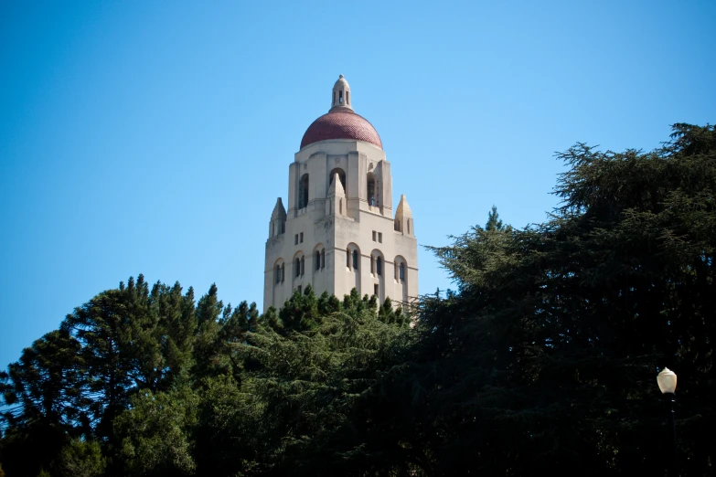 a building with a domed top sitting next to trees