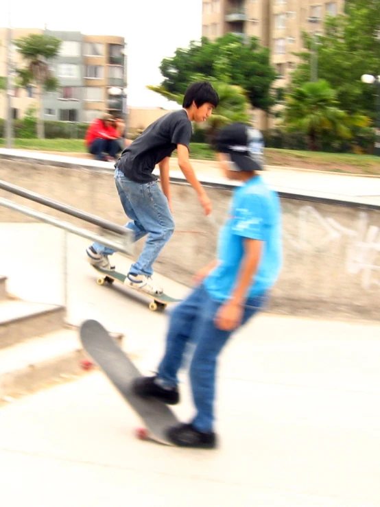 two boys with skateboards are going down stairs