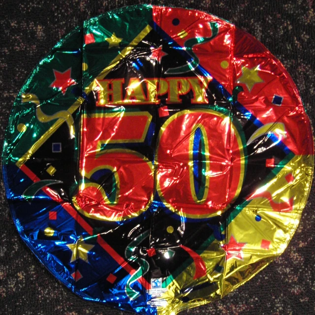 a circular shaped 50th birthday cake has a large number on it