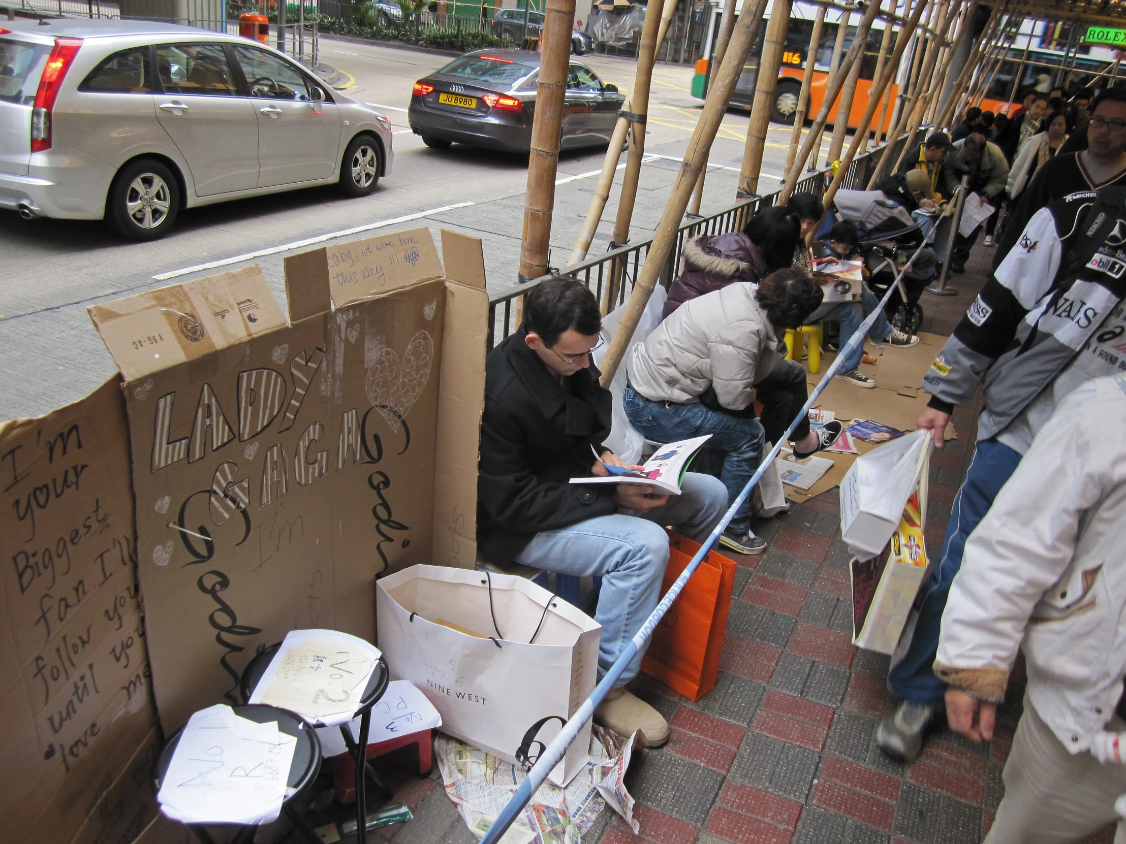 a man is sitting on a sign outside of a building