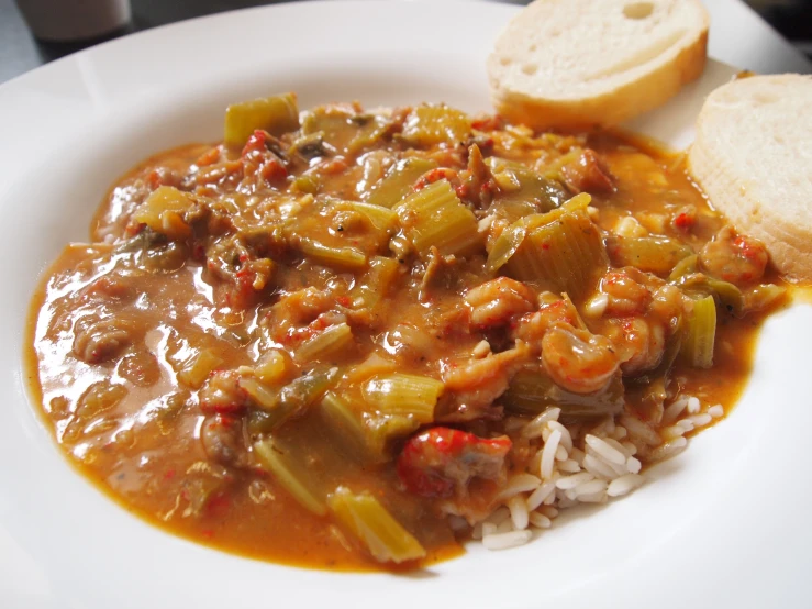 a bowl of rice, meat and vegetable stew