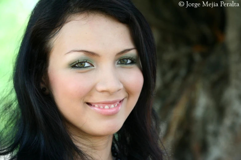 a pretty young lady with brown hair smiling