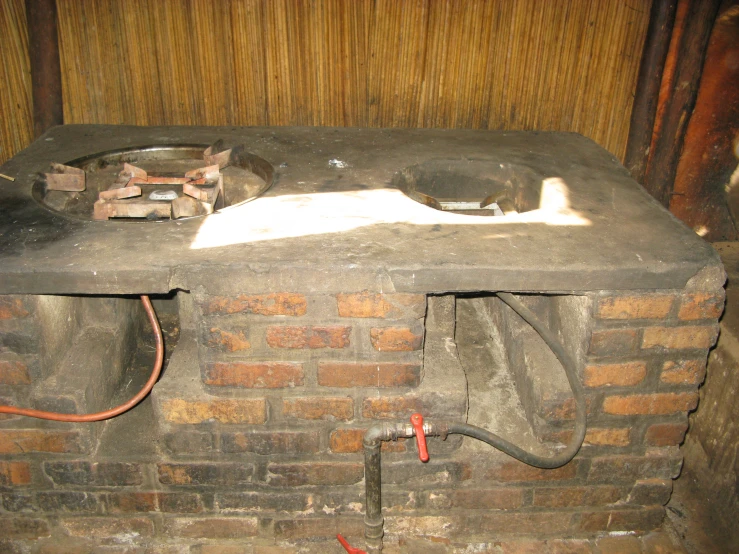 a small cat laying on top of a brick oven