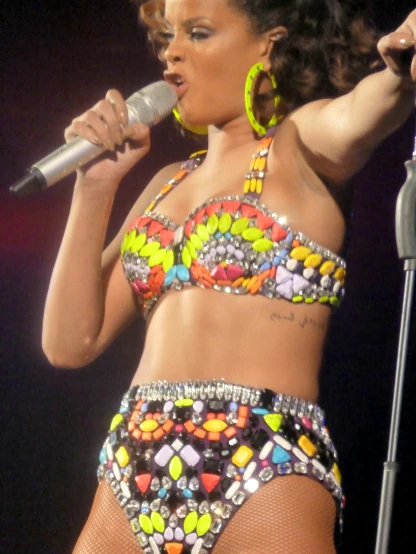 singer in bikini singing on stage with a microphone
