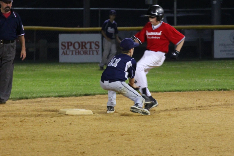 a small boy sliding into home plate with a baseball