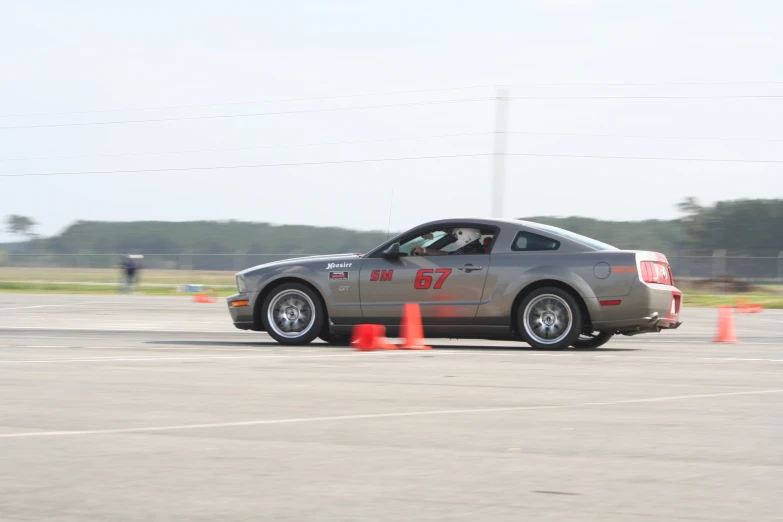 a car traveling around an orange cone at an intersection