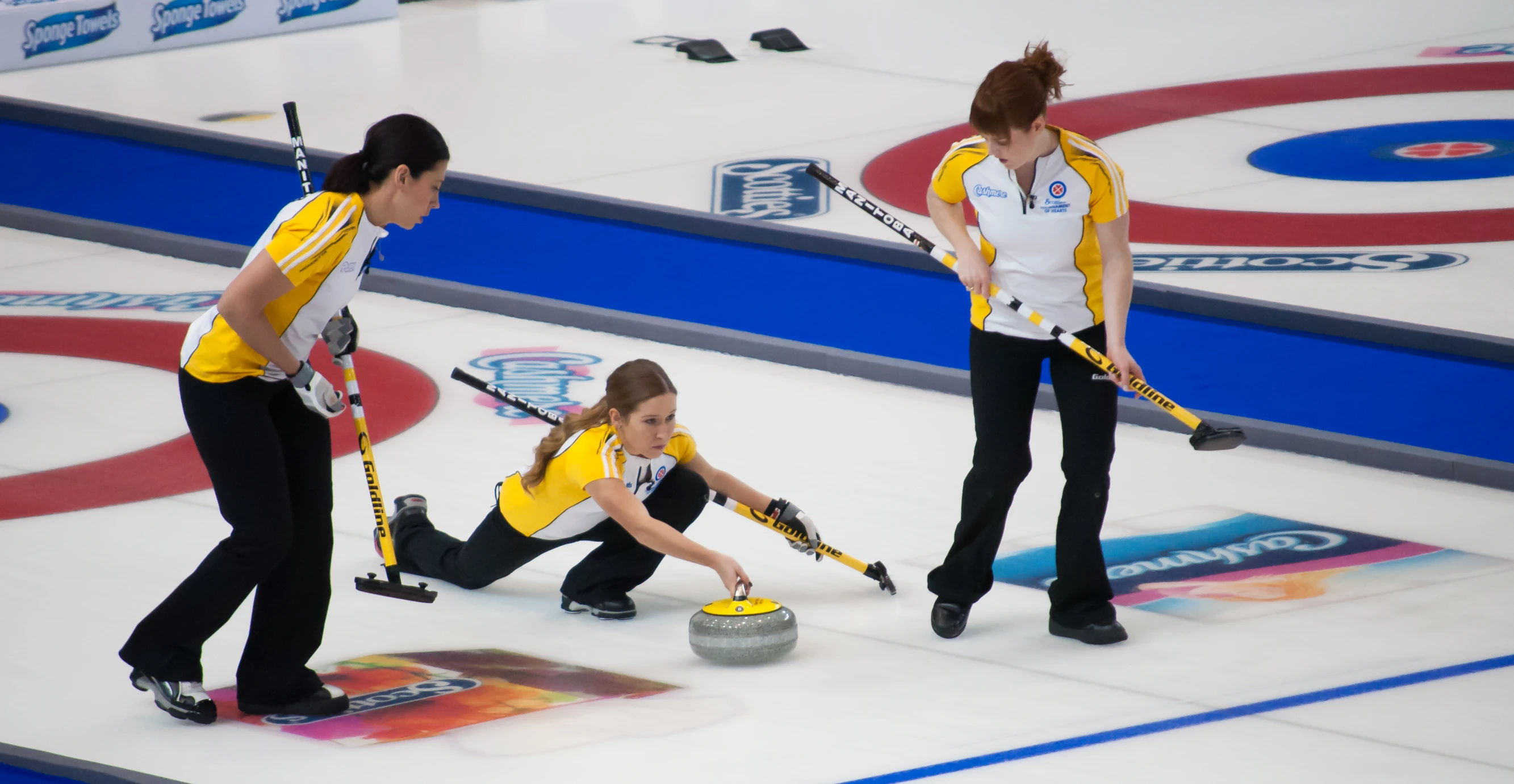 curling competition in progress with female crew members