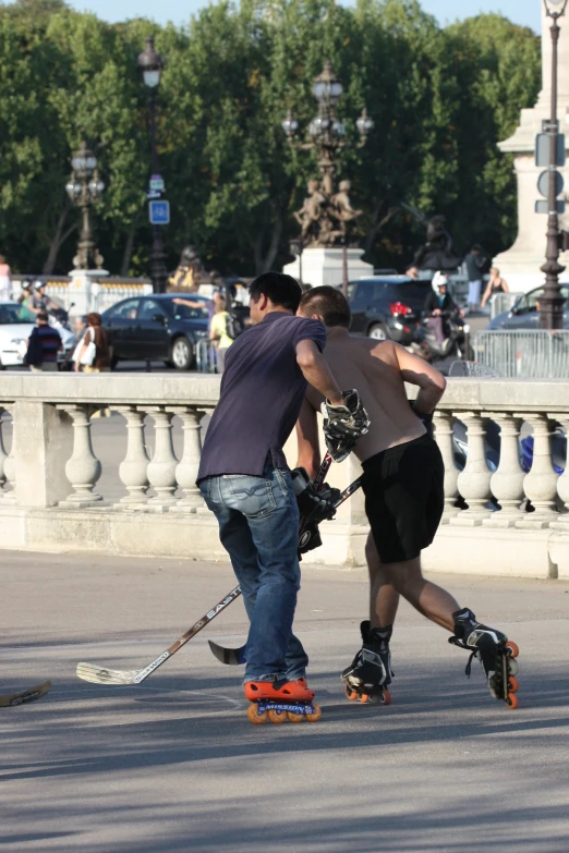 two people playing in the street on skateboards