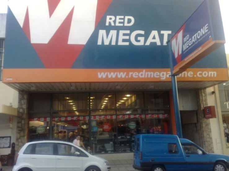 red mega at shopping center sign with cars parked in front