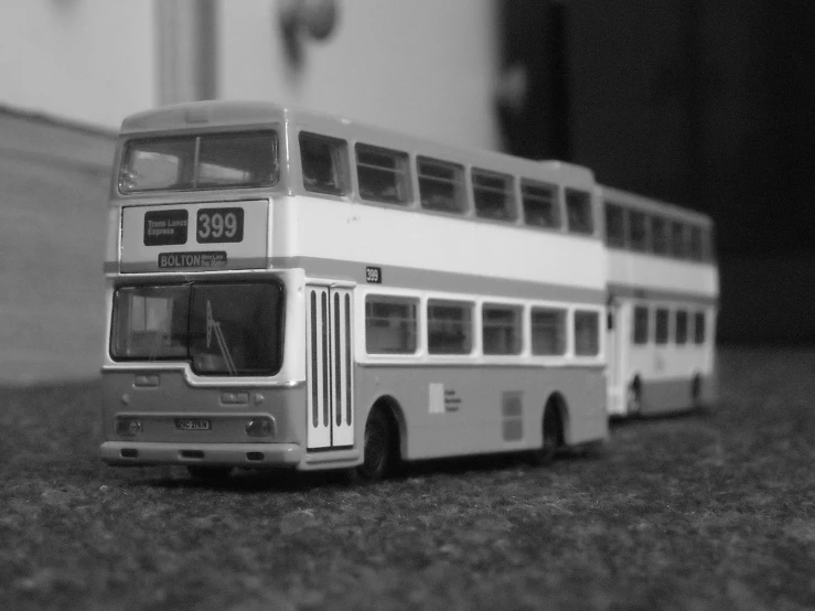 a toy model double decker bus on top of a rug