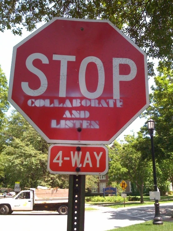 a stop sign with words taped on it