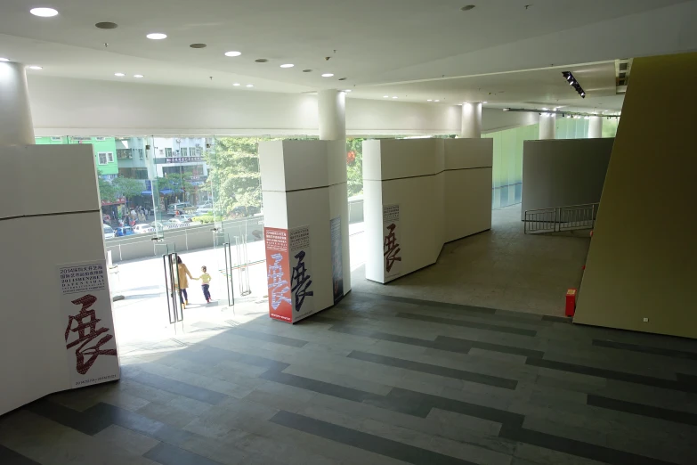 a room with multiple white walls and red signs in the wall