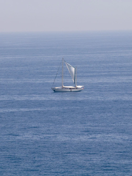 a sailboat floating on the water with lots of waves