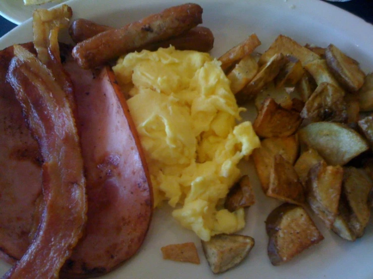 a plate full of breakfast foods on a table