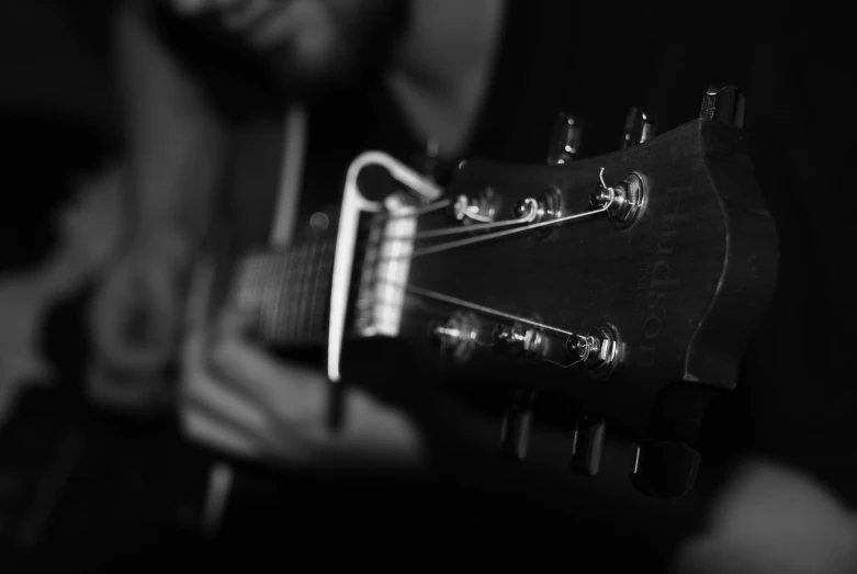 man holding his guitar in front of him