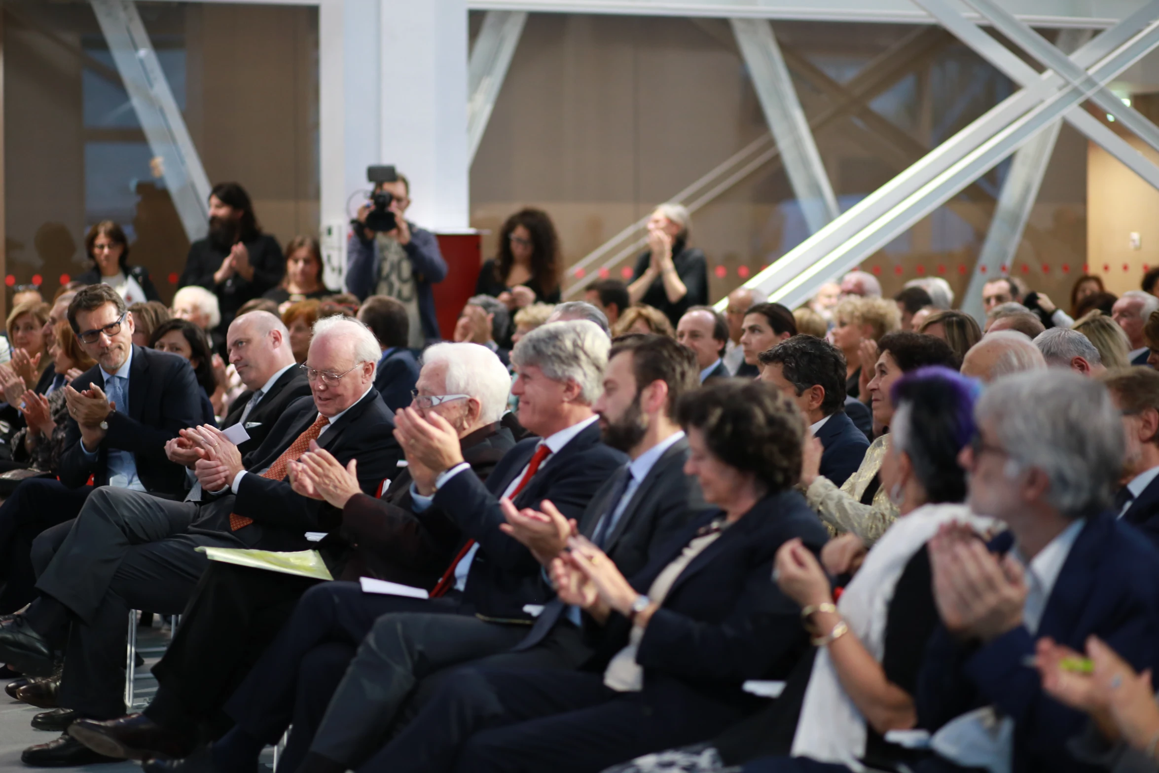 a group of men and women who are clapping