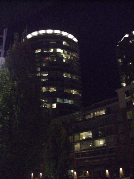 city buildings lit up at night in the distance