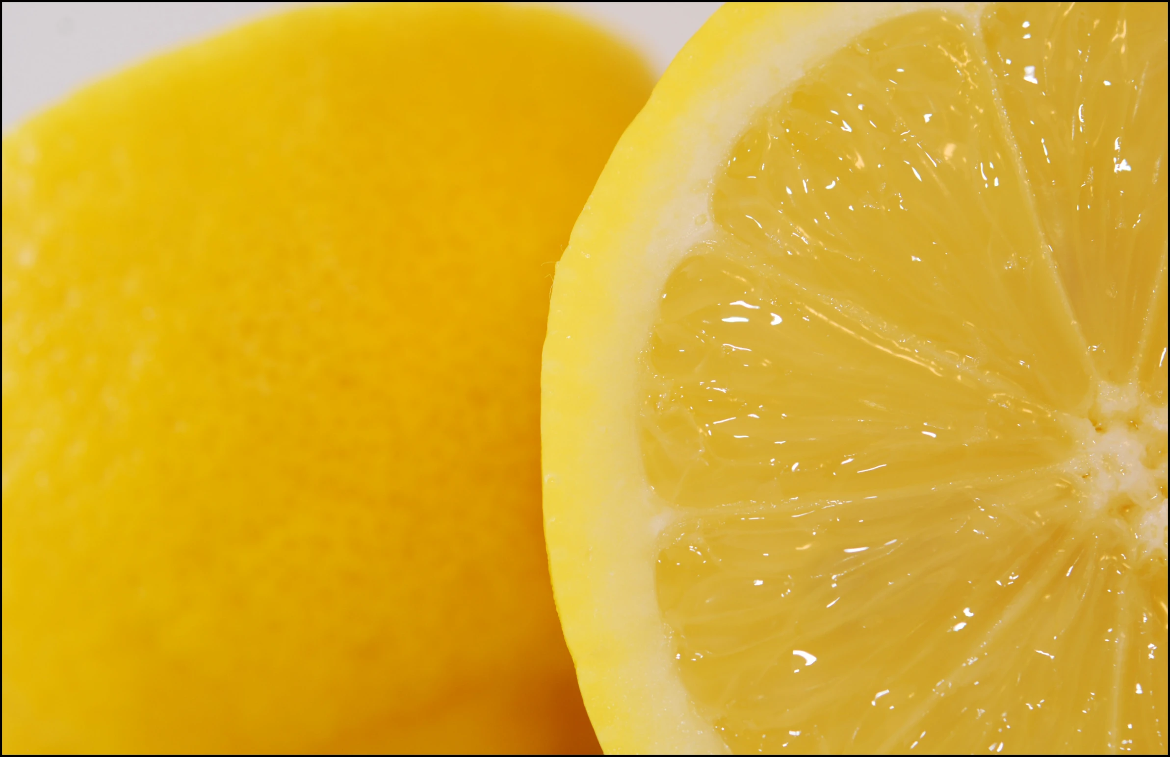 a lemon is cut into pieces with water droplets