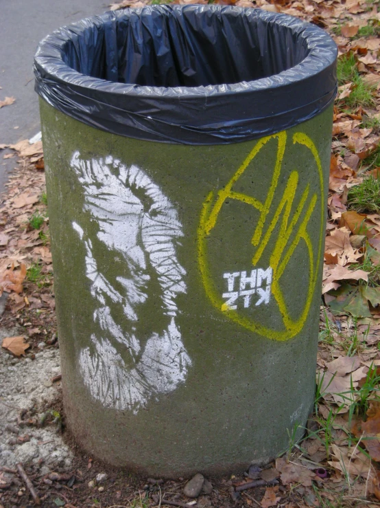 a trash can with the image of a man painted on it