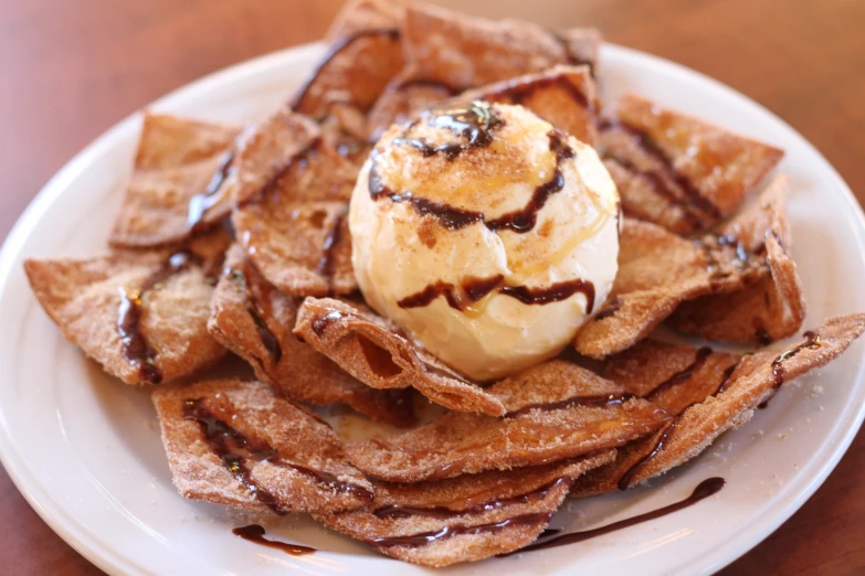 a plate topped with waffles and a cone of ice cream