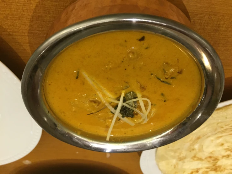 an indian meal served in a bowl with the main portion