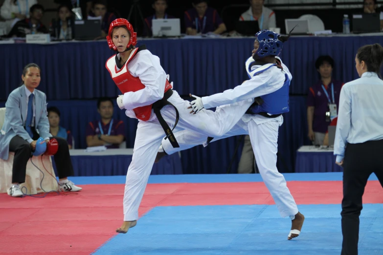 man kicking another person while standing on one leg