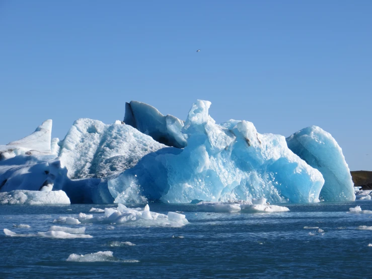 the water is very blue and bright with ice chunks