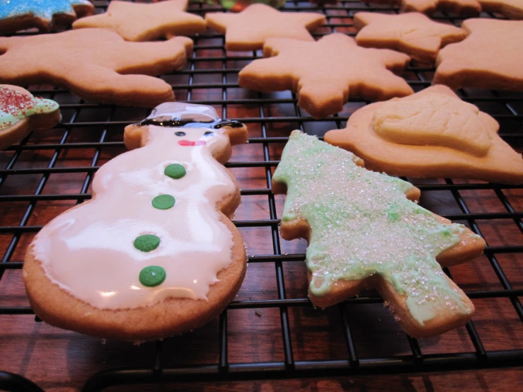 cookies are decorated like snowmen and trees