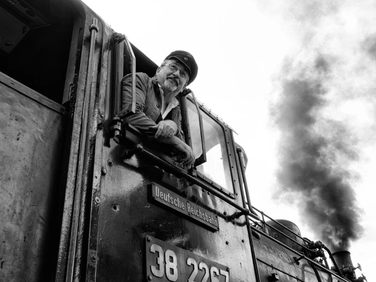 a man is sitting on the side of a train