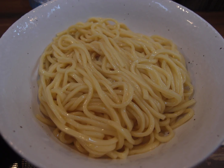 a white plate with some noodles in it
