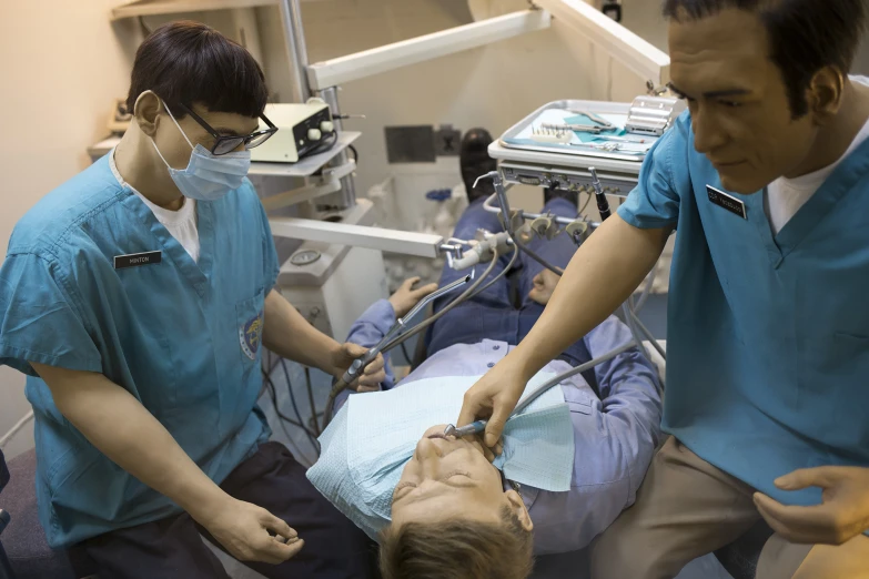 some medical professionals are performing a procedure on a patient