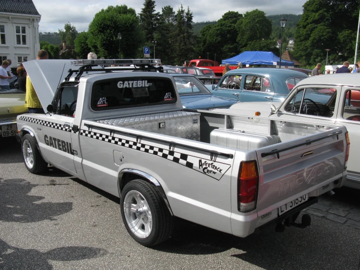 a truck with checkered writing in the back parked