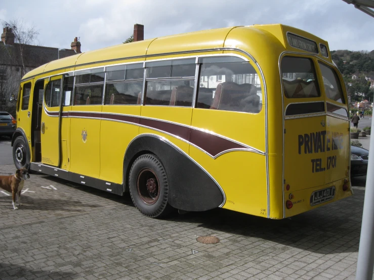 a yellow bus that is sitting on the side of the street