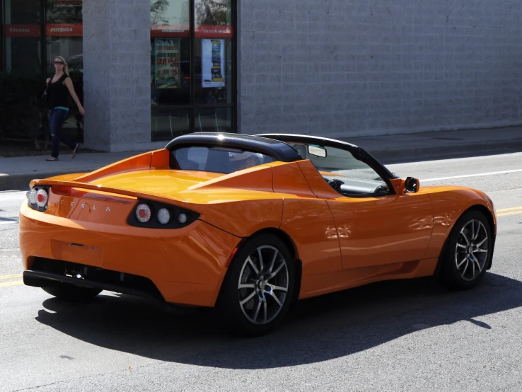 the sports car is parked on the side of the street