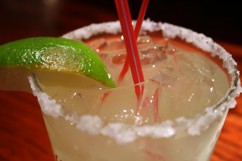 an old fashioned cocktail with a lime and ice