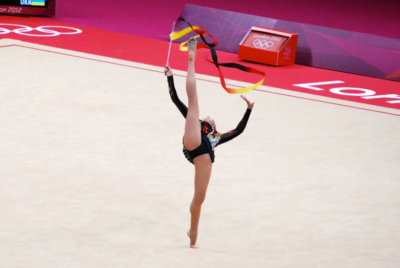 the woman is doing a handstand on her back