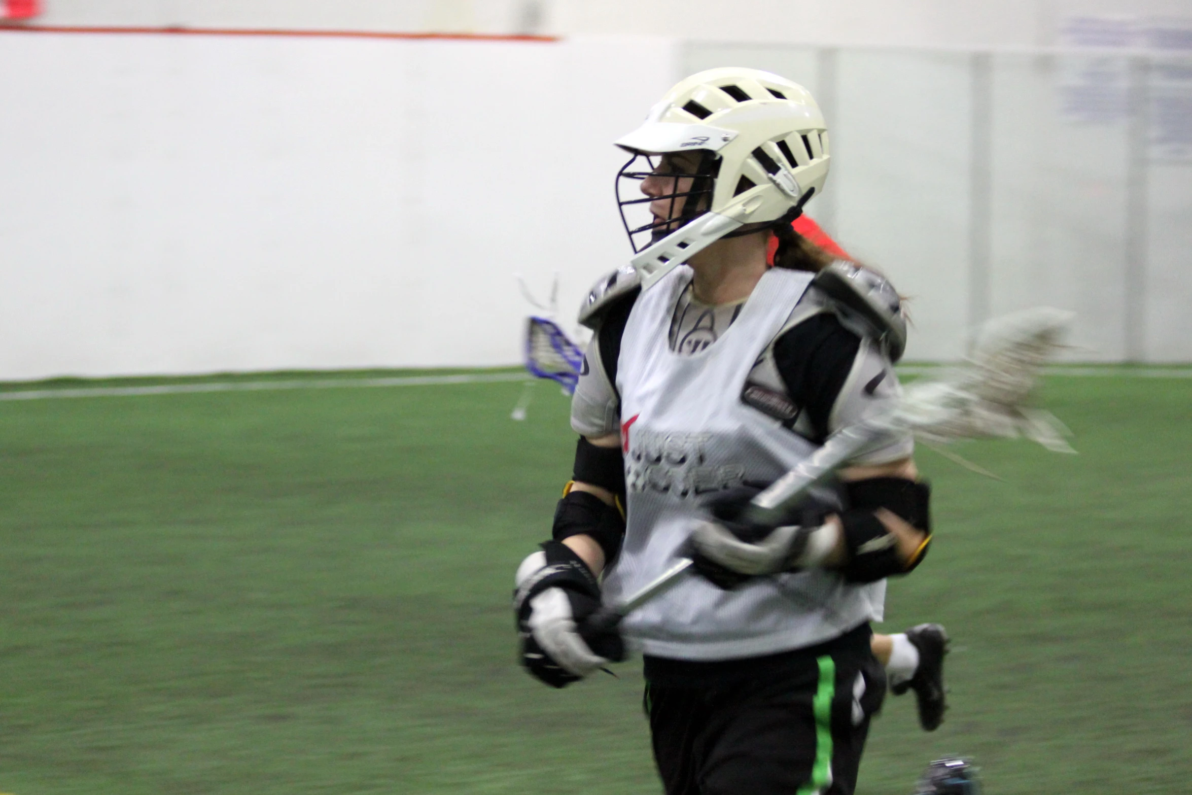 the lacrosse goalie is running after the ball