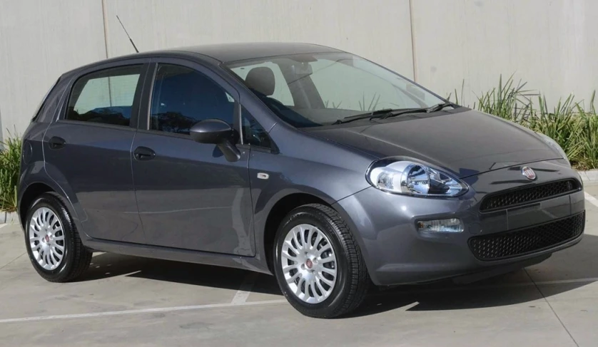 a gray car is parked in a parking lot