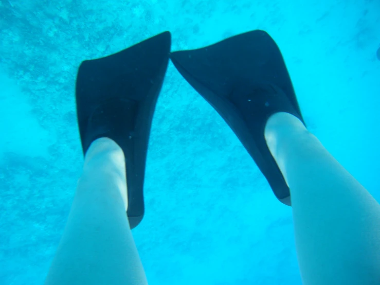 a person wearing flip flops under the water