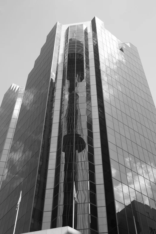 a tall building with large glass windows and a mirror