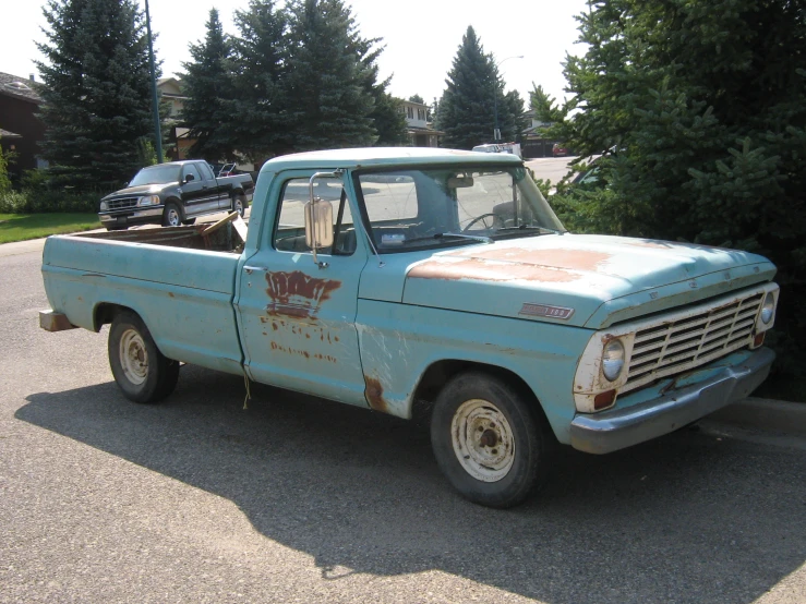 an old, rusted - down blue truck with the word'war is coming on it '