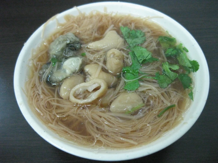 a small bowl of noodle soup with broth