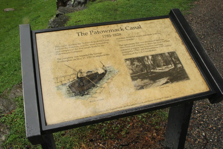 an information plaque is located near the grassy ground