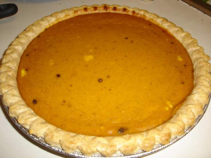 a pumpkin pie sitting on top of a white counter