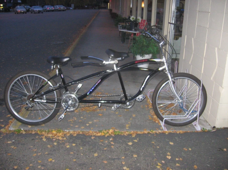 an upside down bicycle is  up on the side walk