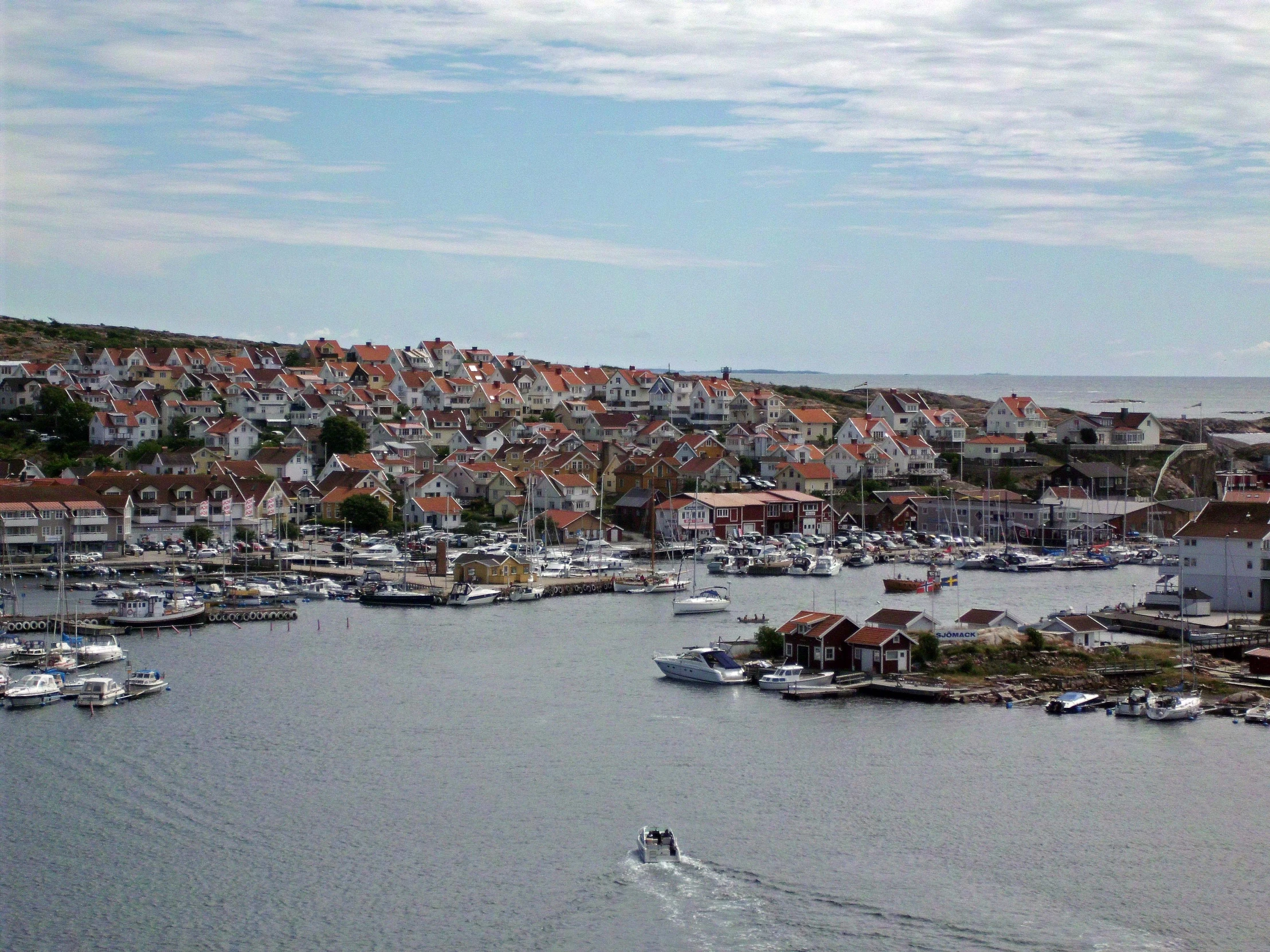 boats in the water and houses next to them