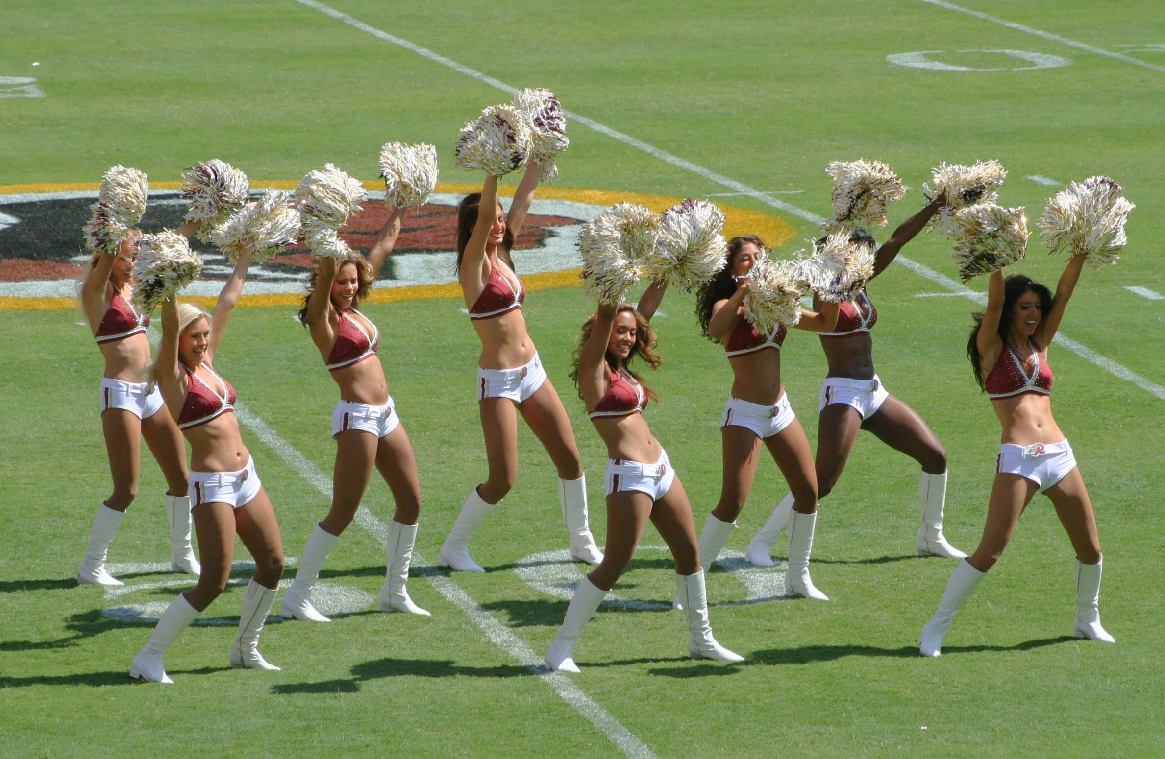 a bunch of cheerleaders are dancing in formation